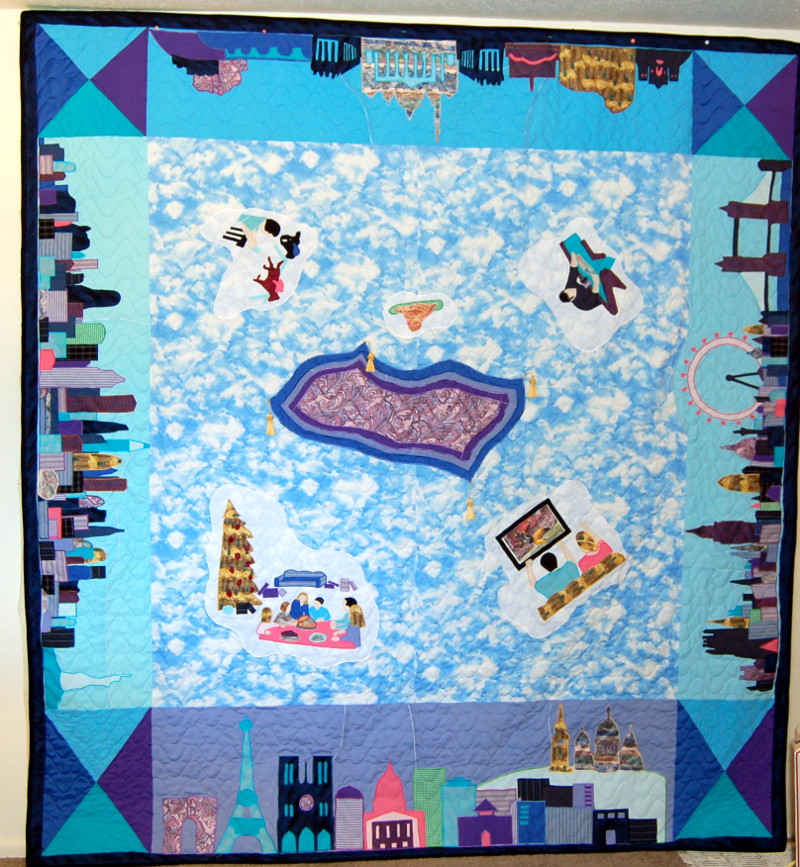 Bereavement quilt depicting magic carpet going to four major cities, using ties to make the skylines.