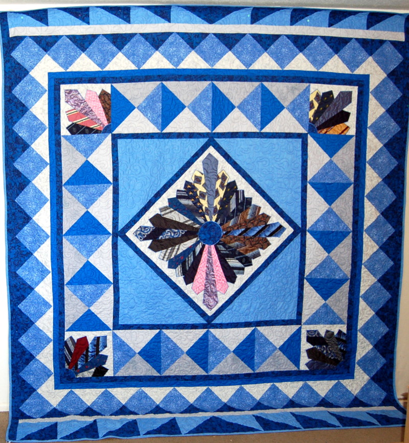 Bed-sized bereavement quilt made for daughter with father's ties displayed diamond shaped array