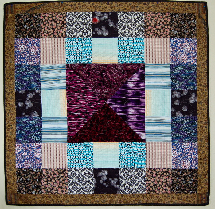 Traditional bereavement quilt displaying mother's clothes